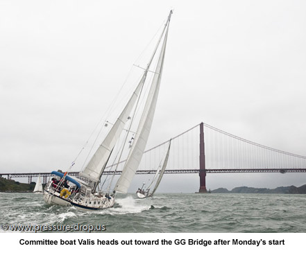 Committee boat Valis heads out toward the GG Bridge after Monday's start.