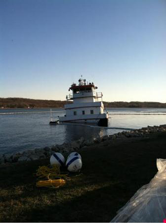 The Coast Guard, Illinois EPA, Illinois DNR and local emergency crews continue to respond to a vessel sinking and oil discharge into the Mississippi River near LeClaire, Iowa, Tuesday. The Stephen L. Colby, a 144-foot towboat, struck a submerged object near LeClaire, Iowa, causing it to sink Monday evening. Approximately 700 gallons of oily water mix have been recovered. U.S. Coast Guard photograph.