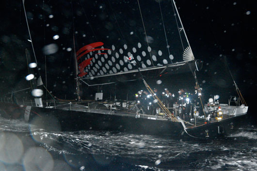 Early arrival. COMANCHE storms across the St David's Lighthouse finish line early today to smash the Newport Bermuda Race record. Photo: Barry Pickthall/PPL