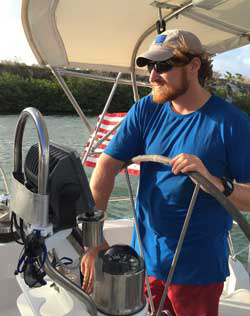 Jacques Soumis at the helm coming into Simpson Bay Marina. Backing into a slip with one foot on either side, trade winds often blowing across the boat present special challenges, Jacques was patient and kept docking fairly boring!