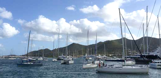 Most of these boats are moving to the choke point of the Simpson Bay Bridge, the causeway bridge is in the background. It takes a high degree of close quartered station keeping to maneuver single screw vessels amongst the crowd.