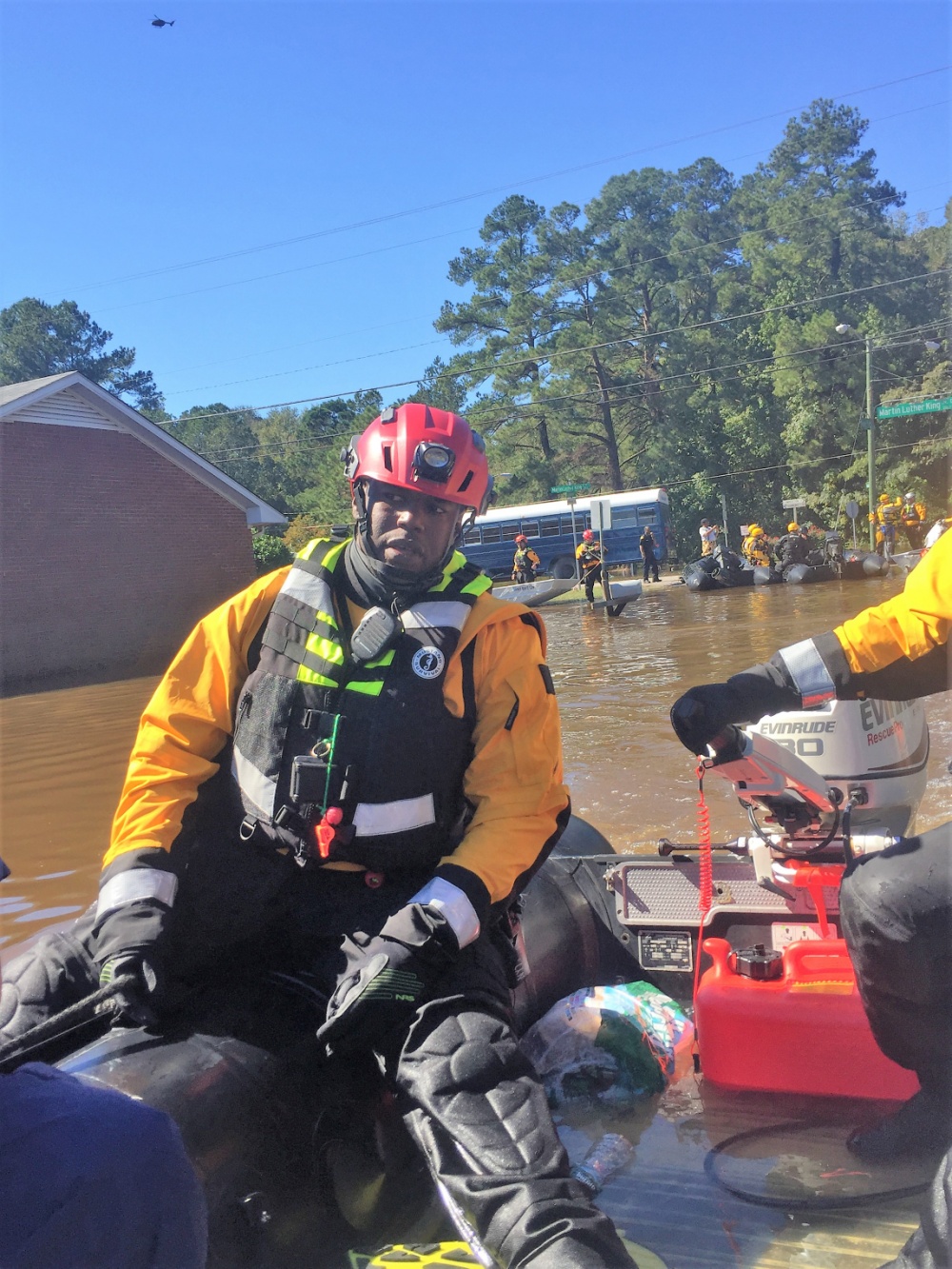 A New York City rescue worker aboard a boat searches for flood victims in Lumberton, North Carolina, Oct. 10, 2016. The Lumber River flooded the city after Hurricane Matthew. (U.S. Coast Guard photo by Master Chief Petty Officer Louis Coleman/Released)